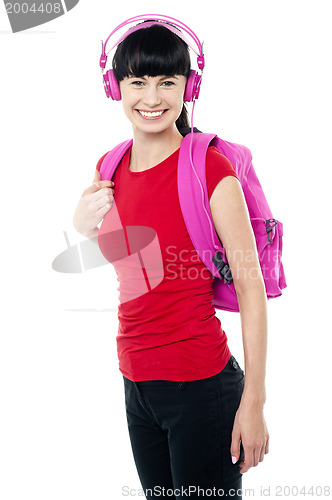 Image of College teen dressed in casuals enjoying music