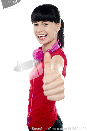 Image of Carefree teenager flashing thumbs up sign