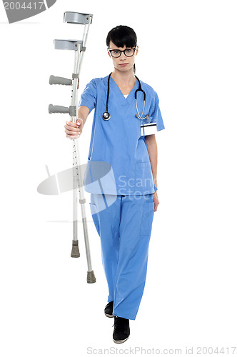 Image of Sad doctor holding up crutches in hand