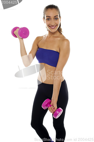Image of Middle aged woman posing with pink dumbbells