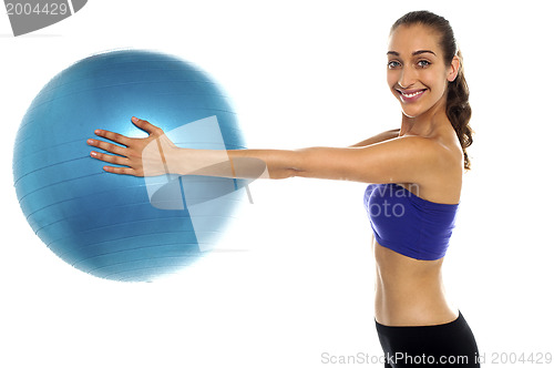 Image of Fitness enthusiast holding a swiss ball