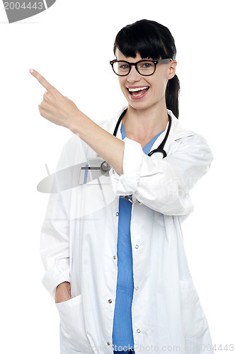 Image of Cheerful physician pointing away, copy space area
