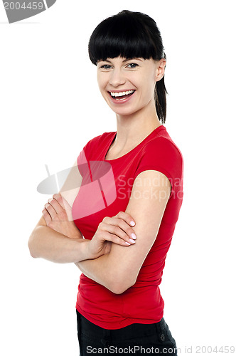 Image of Pretty slim lady in bright red top, arms folded