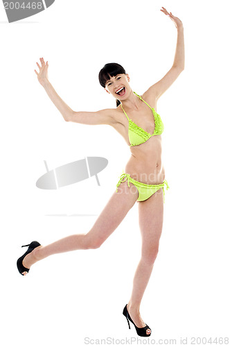 Image of Joyous woman in green lingerie dancing in joy