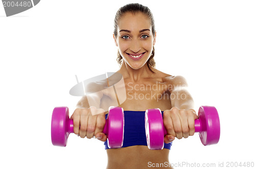 Image of Lady lifting dumbbells, arms outstretched