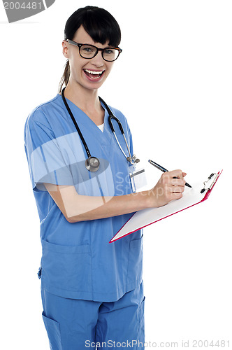 Image of Medical nurse jotting down notes on writing pad