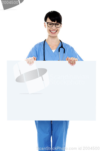 Image of Medical practitioner holding blank ad board