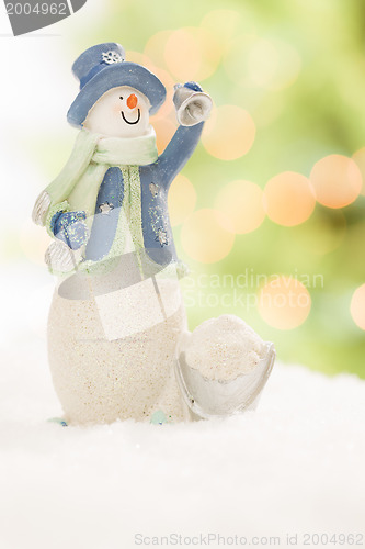 Image of Snowman Statue On Snow Over a Blurry Abstract Background