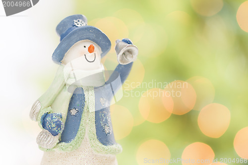 Image of Snowman Statue On Snow Over a Blurry Abstract Background