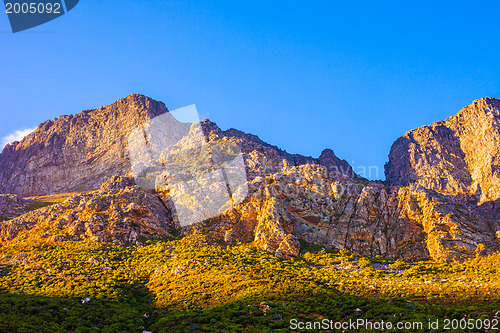 Image of Orange-lit cliffs and blue sky