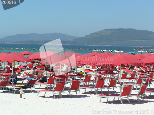 Image of Red parasols on summer beach