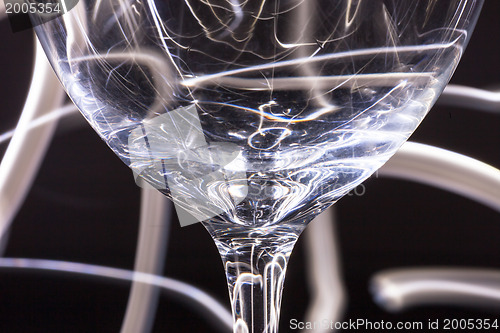 Image of Abstract light tracks behind glass