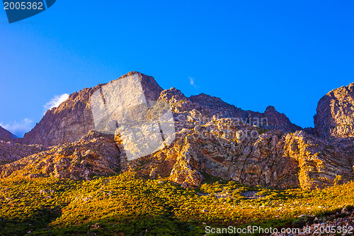 Image of Orange-lit cliffs and blue sky