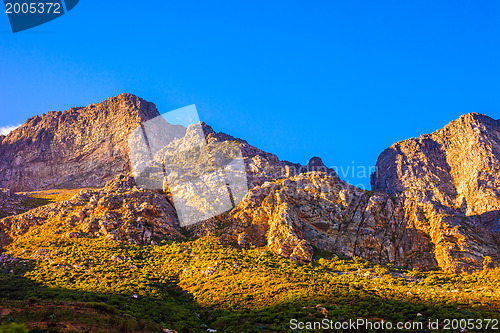 Image of Orange-lit cliffs and blue sky