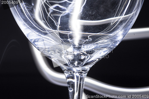 Image of Abstract light tracks behind glass