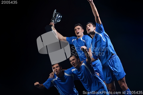 Image of soccer players celebrating victory
