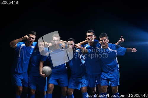 Image of soccer players celebrating victory