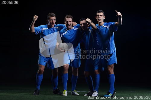 Image of soccer players celebrating victory