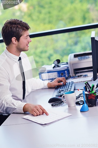 Image of happy young business man at office
