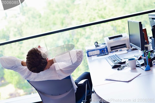 Image of happy young business man at office