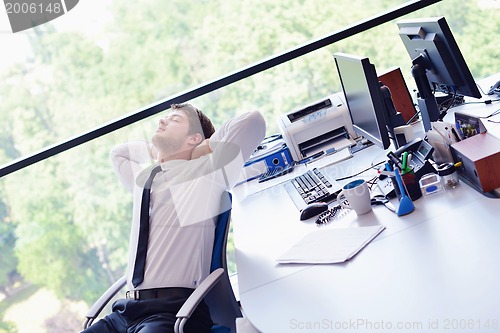 Image of happy young business man at office