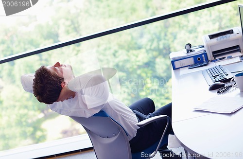 Image of happy young business man at office