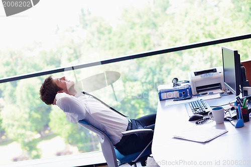 Image of happy young business man at office
