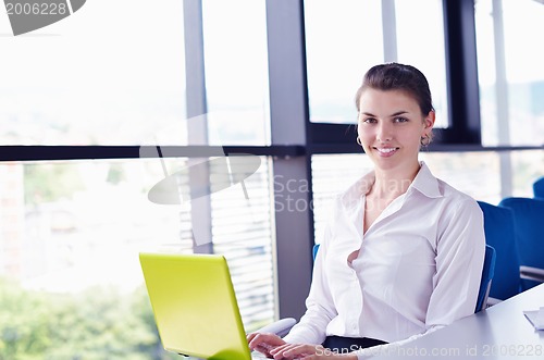 Image of Young pretty business woman with notebook in the office