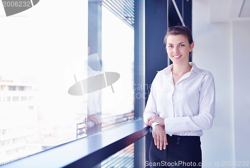 Image of business woman with her staff in background at office
