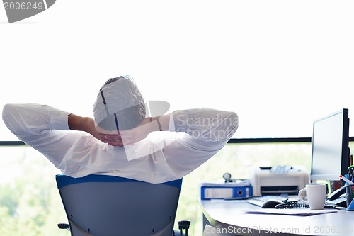 Image of happy young business man at office