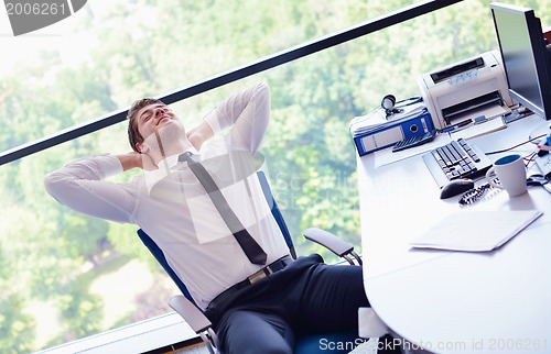 Image of happy young business man at office