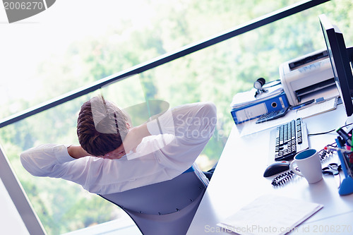 Image of happy young business man at office