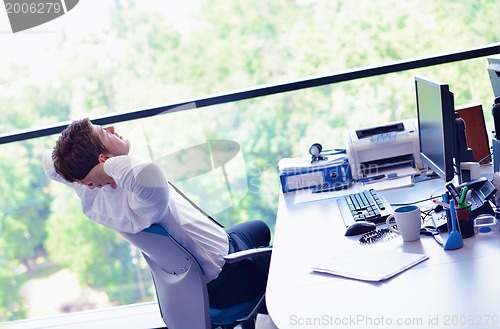 Image of happy young business man at office