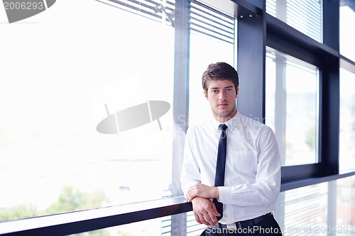 Image of business man  on a meeting in offce with colleagues in backgroun