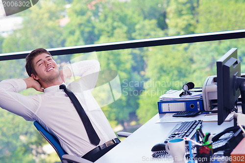 Image of happy young business man at office
