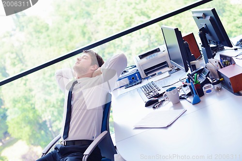 Image of happy young business man at office