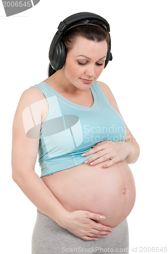 Image of Pregnant belly with headphones