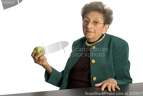Image of senior woman with apple