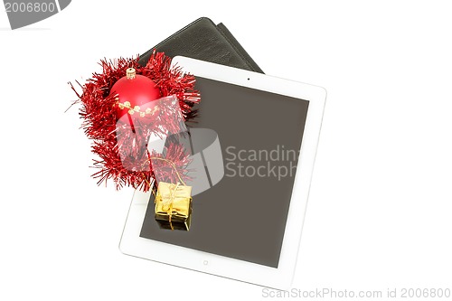 Image of gift white tablet with Christmas ball, box and red chain