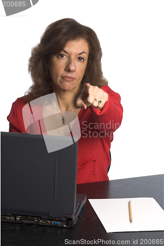 Image of woman at desk pointin
