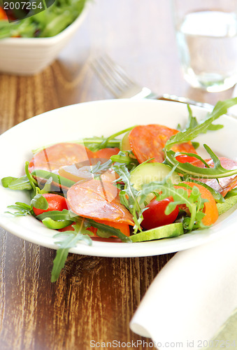 Image of Sausage or Chorizo  with Rocket salad 