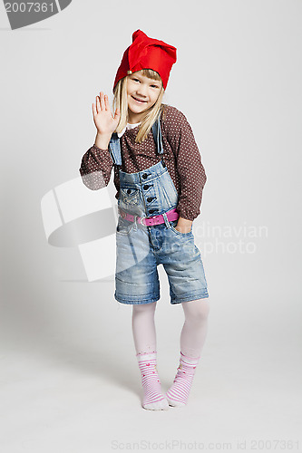 Image of Smiling girl wearing Christmas hat and waving
