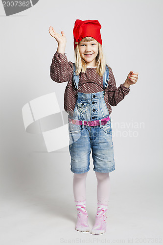 Image of Smiling girl wearing Christmas hat and waving