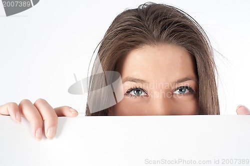 Image of woman  hiding behind billboard