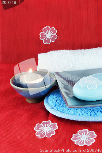 Image of Burning candle with soap in a dish