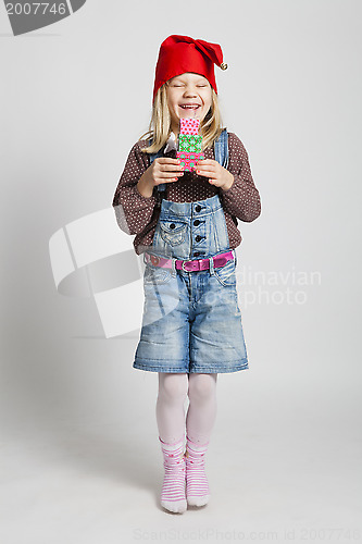 Image of Happy girl holding Christmas gifts