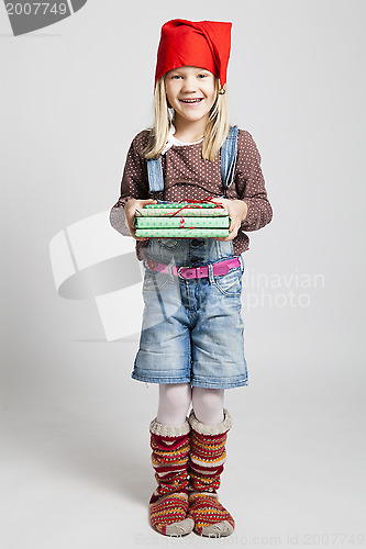 Image of Smiling girl holding Christmas presents