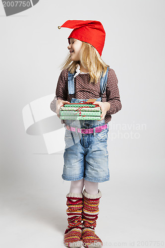 Image of Happy girl holding Christmas gifts