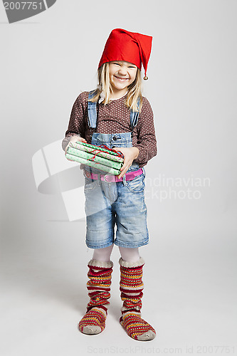 Image of Smiling girl holding Christmas presents