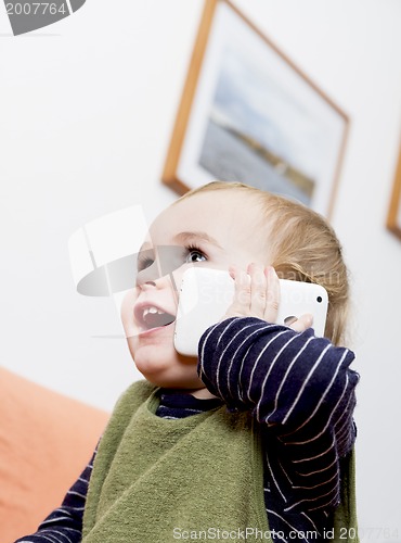 Image of young child on couch with cell phone